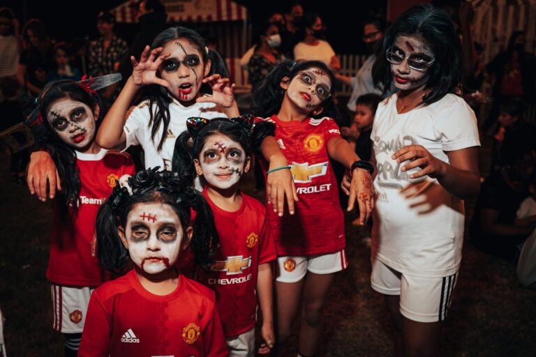 group of young girls with spooky makeup celebrate halloween
